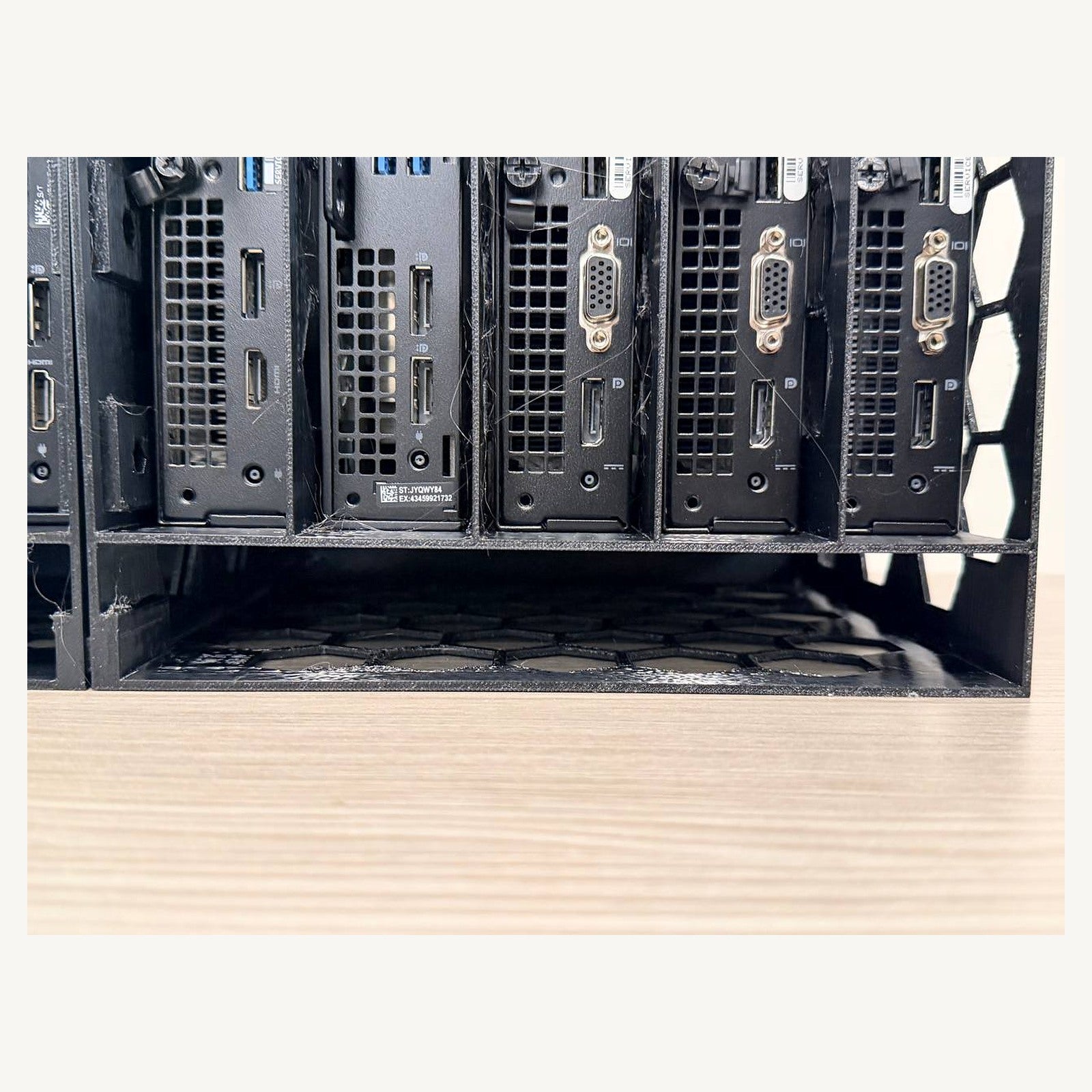 Lower storage compartment beneath the Dell Micro bays, sized to organize compatible power adapters
